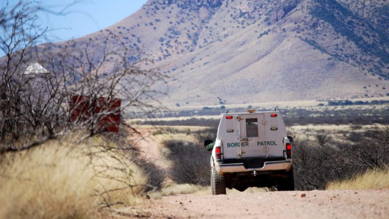 Border patrol truck with mountains